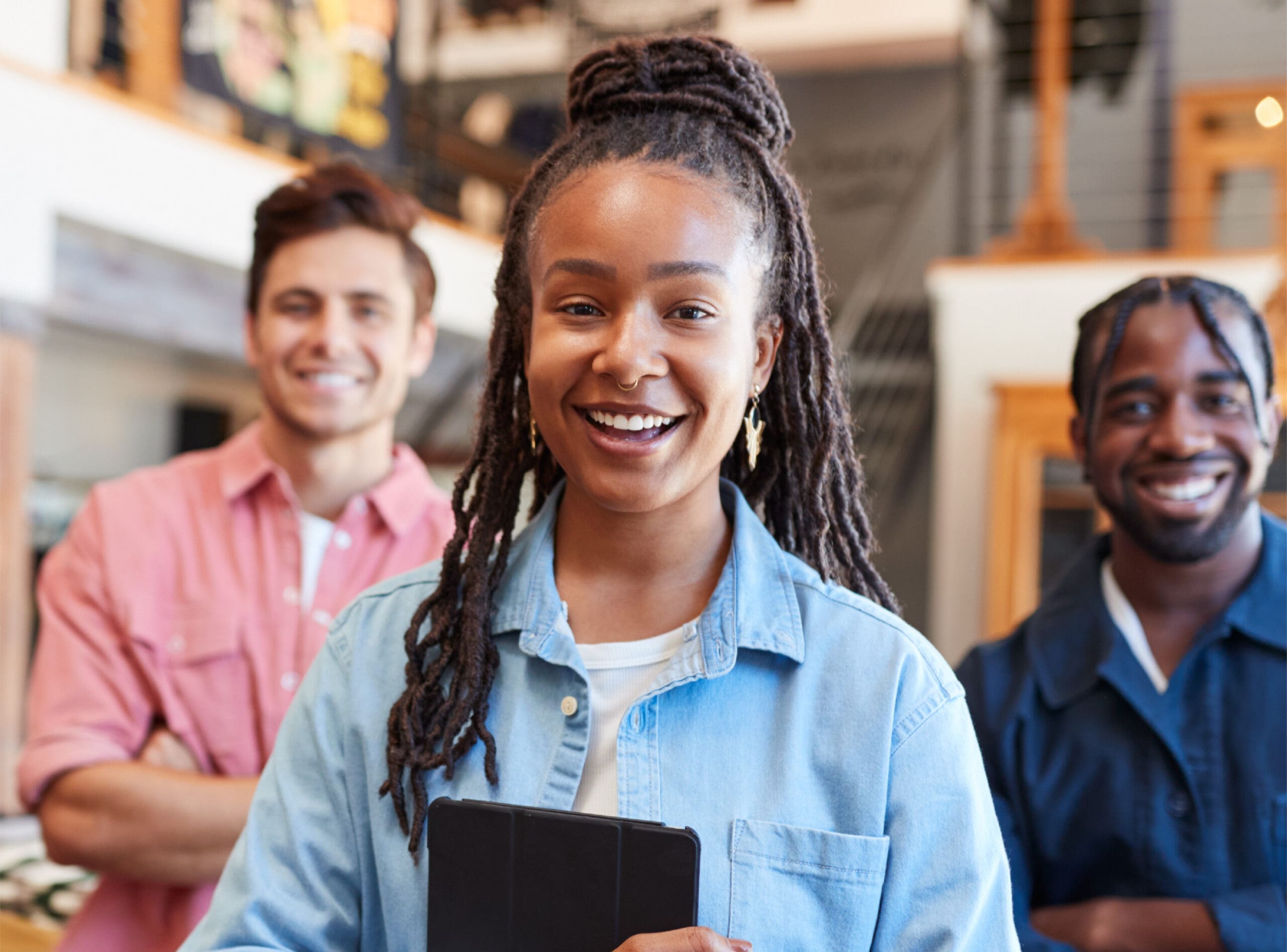 Young woman and two men standing and smiling